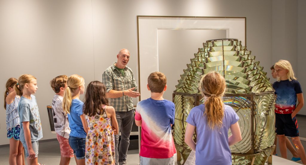 CBMM’s Exhibition Designer & Projects Manager Jim Koerner leads students in the Museum Masters summer camp on a tour of the new Welcome Center. (Photo by Sharon Thorpe)