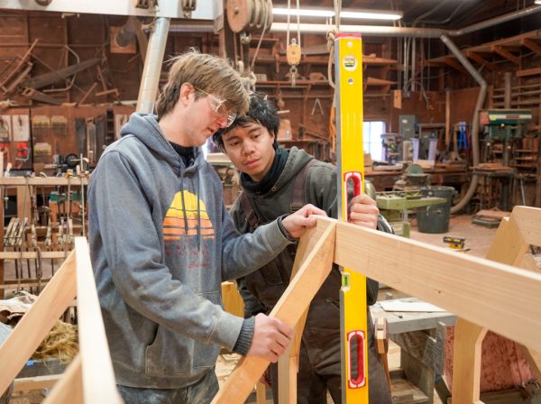 Ben Heyer and Roland Payabyab work on the Lighthouse Skiff.