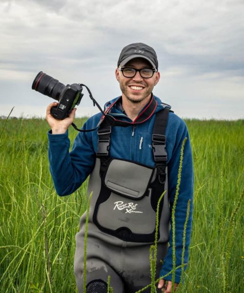 Kittredge-Wislon-Michael-Snyder-768x922 - Chesapeake Bay Maritime Museum Michael O. Snyder stands with a camera.